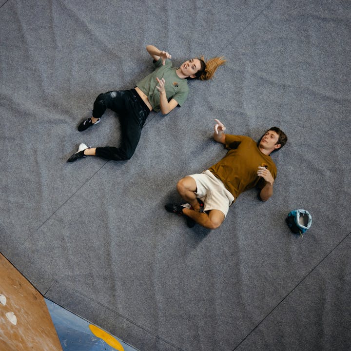 Two climbers wearing Black Diamond climbing apparel in the gym. 