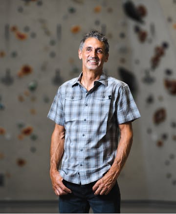 Reini standing inside his greatest contribution to the climbing community, a climbing gym.