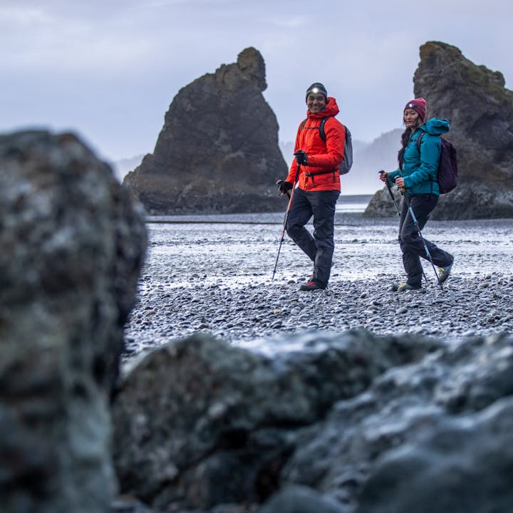 Hikers on the beach in the rain. 