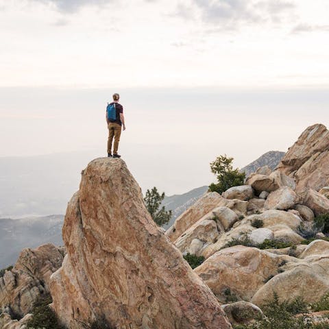 man standing on top of a rock formation