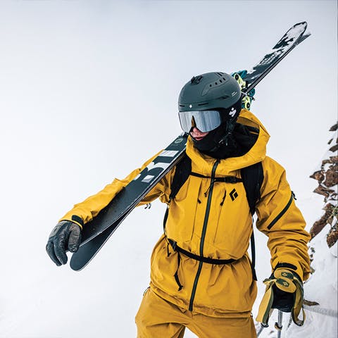 Black Diamond Athlete Parkin Costain hiking to the top of a line.