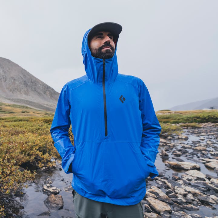 A hiker wears the Black Diamond Stormline Anorak to shelter from the rain. 