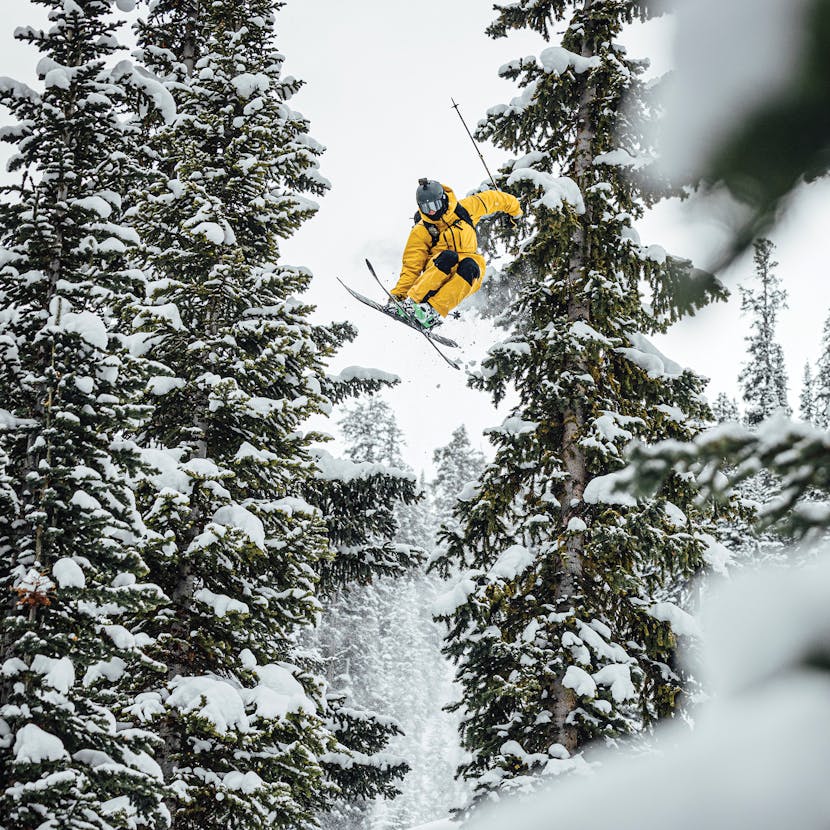 Black Diamond Athlete Parkin Costain gapping between two trees.