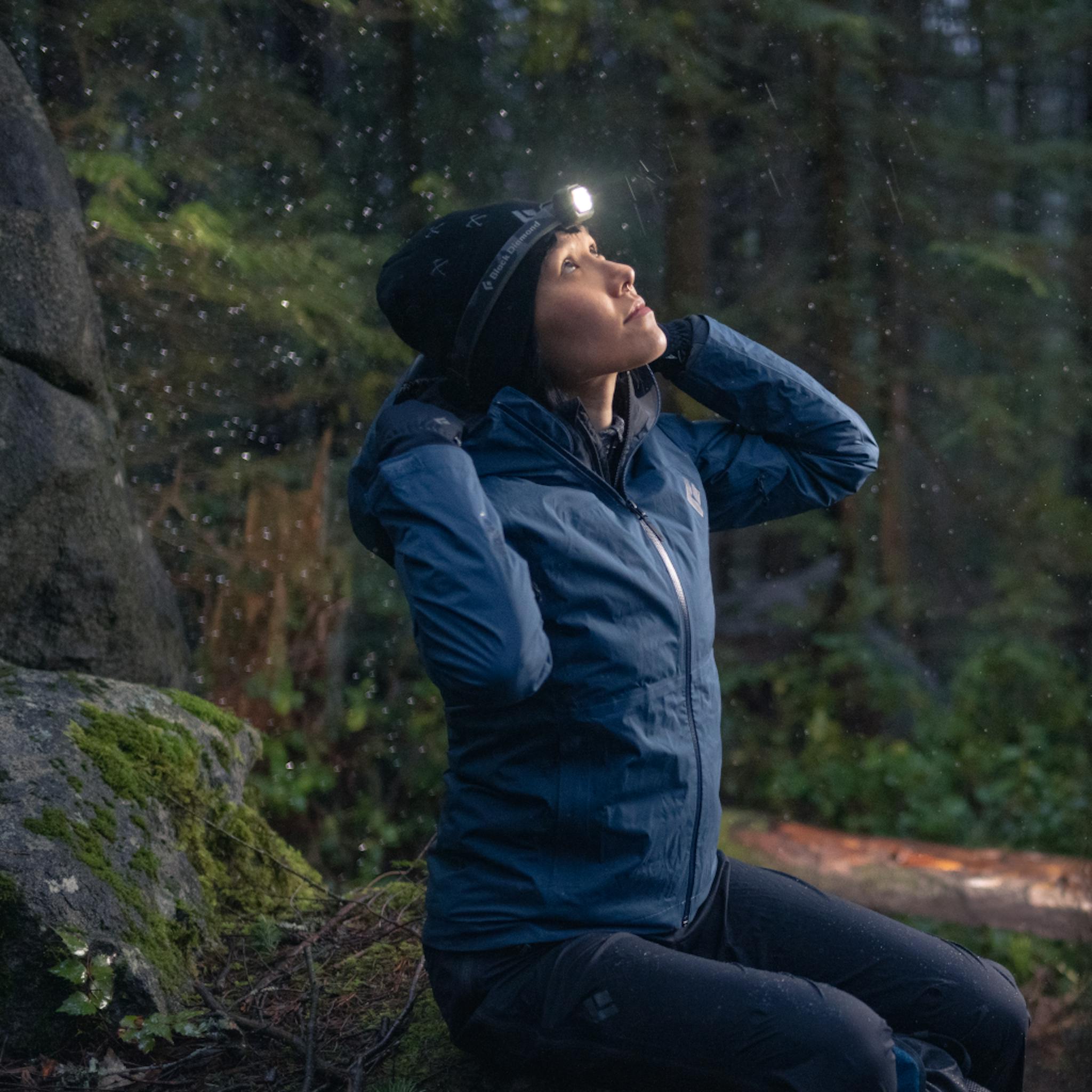 A hiker puts up the hood of her Stormline shell as it starts to rain.