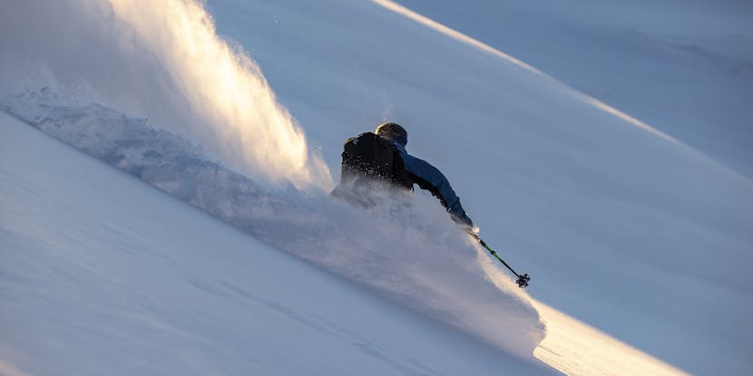 Black Diamond Athlete Mike Barney making a turn in some deep snow.