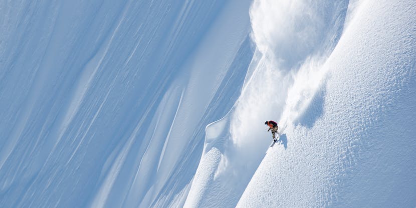 Black Diamond athlete Eric Jackson snowboarding a big AK line.