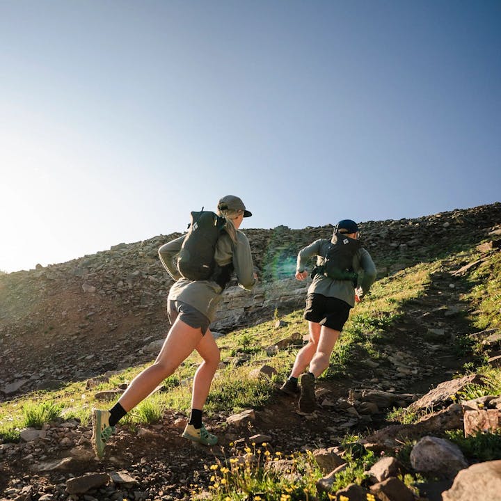 Photograph by Christian Adam of Mary McIntyre and a man trail running