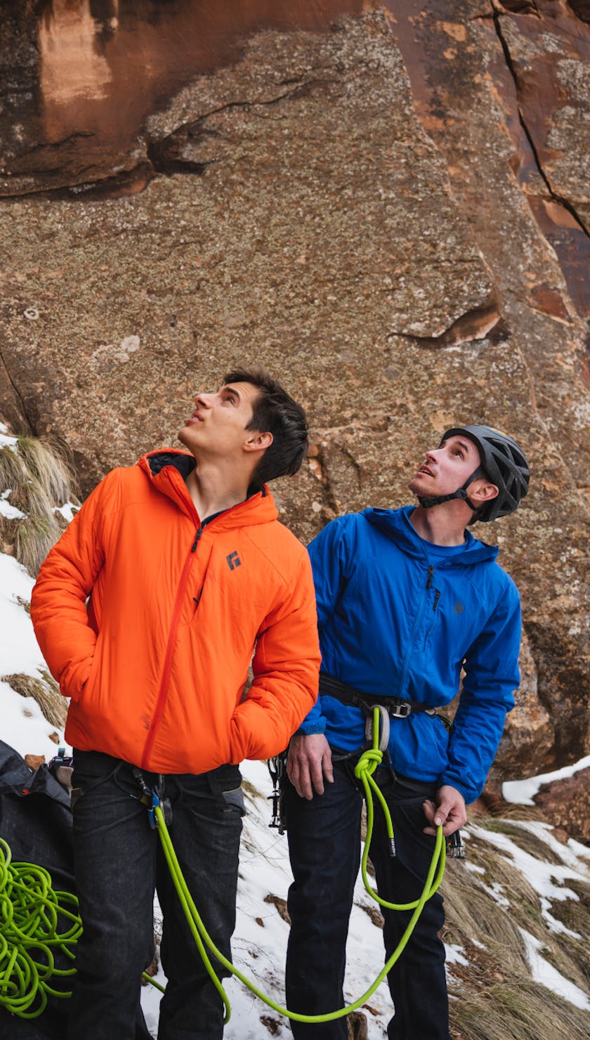Black Diamond athletes Connor Herson and Carlo Traversi inspect a route before climbing it. 