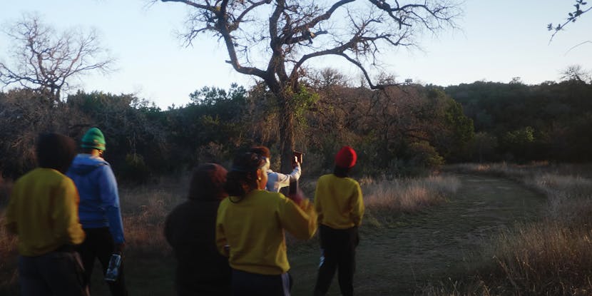 The Black Outside hiking down a trail as a group.