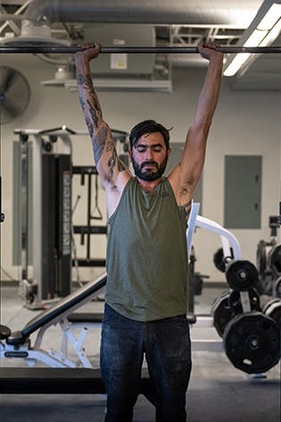 Sam Elias performing an overhead press