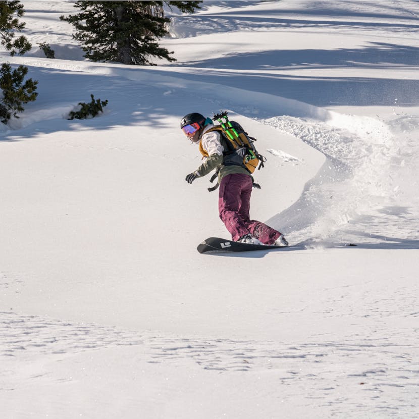 Friend of Black Diamond snowboarding in the backcountry.