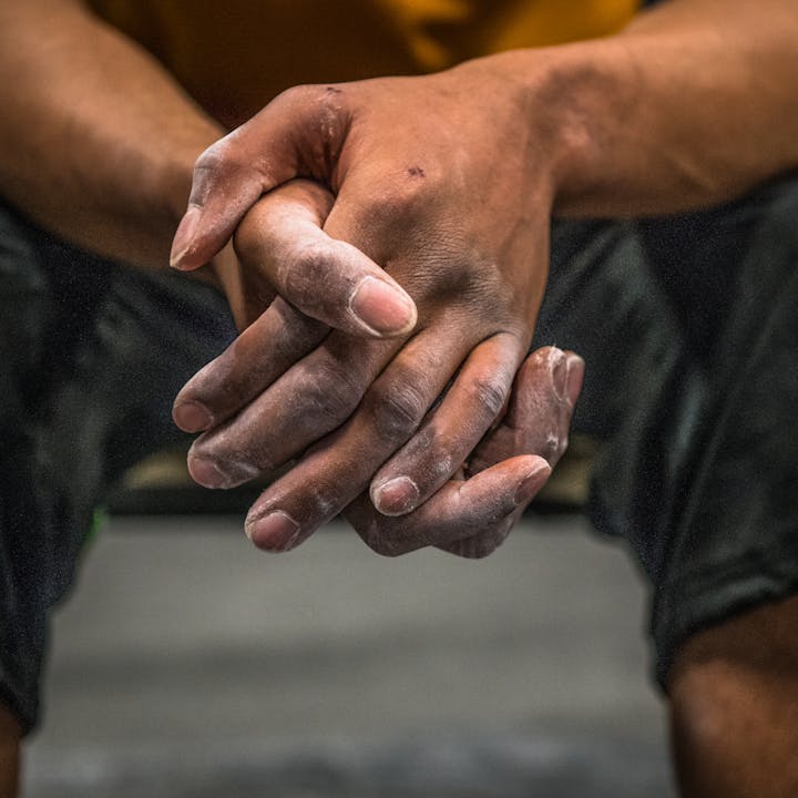 A photo by Andy Earl of a man's hands covered in chalk | Climbers skin care
