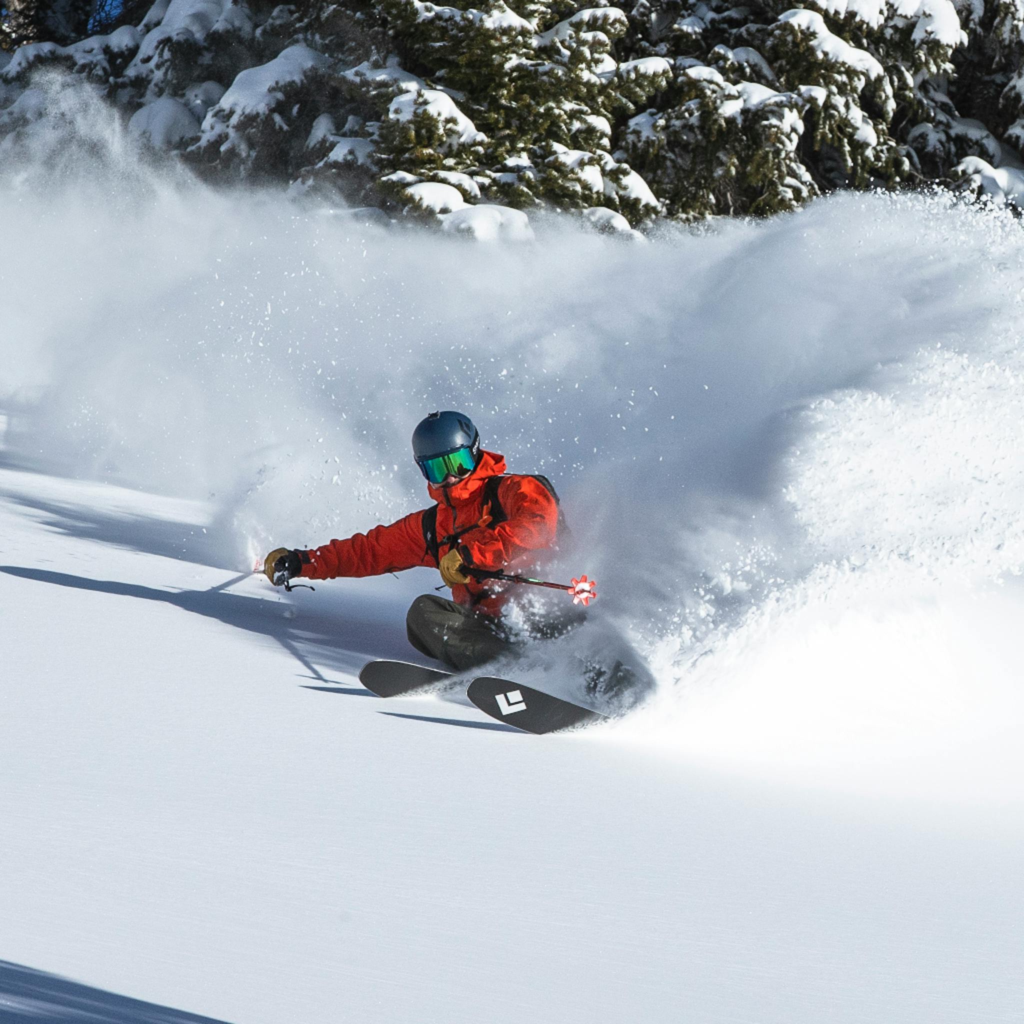A skier makes powder turns in the Recon Stretch Ski Shell.
