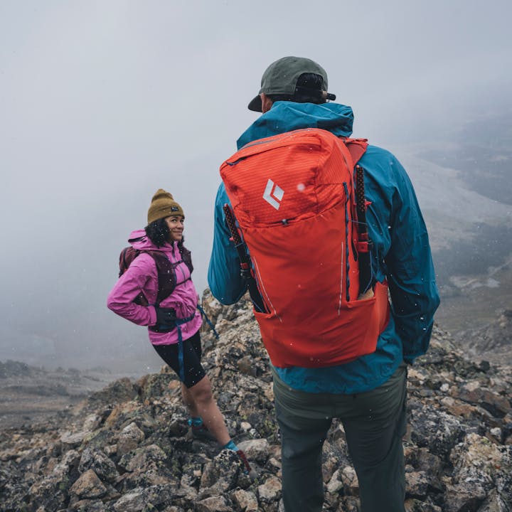 Two hikers wearing the Black Diamond Pursuit series pack. 