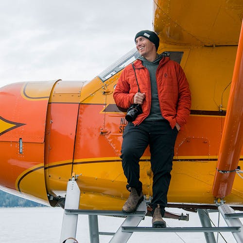 Chris Burkard standing on steps of plane