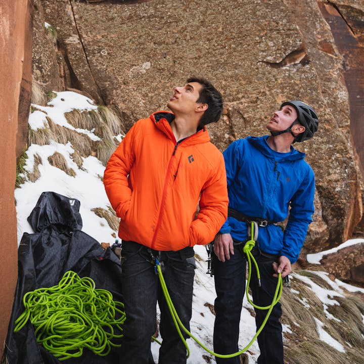 BD Athletes Connor Herson and Carlo Traversi look up at a route, both wearing Black Diamond insulation. 