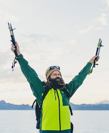 Black Diamond Athlete John Jackson holds up his signature poles triumphantly