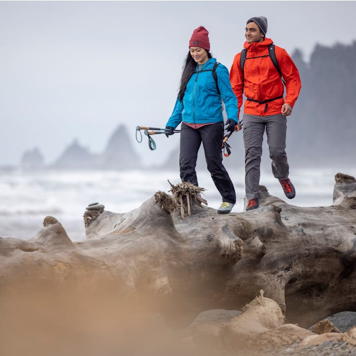 A man and a woman hiking in Black Diamond Rainwear | Women's rain jacket