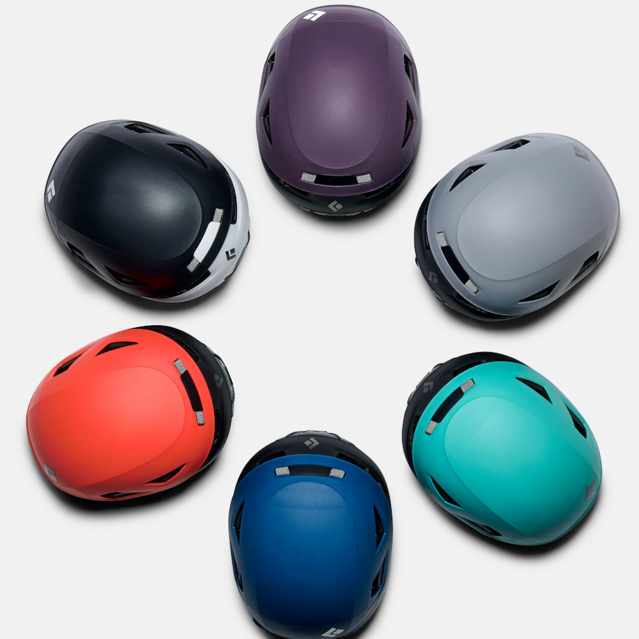 5 Capitan helmets in multiple colors arranged in a flower circle pattern.