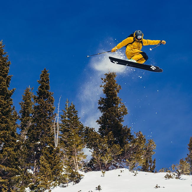 Black Diamond Athlete Parkin Costain doing a straight air through some trees in Crested Butte, CO.
