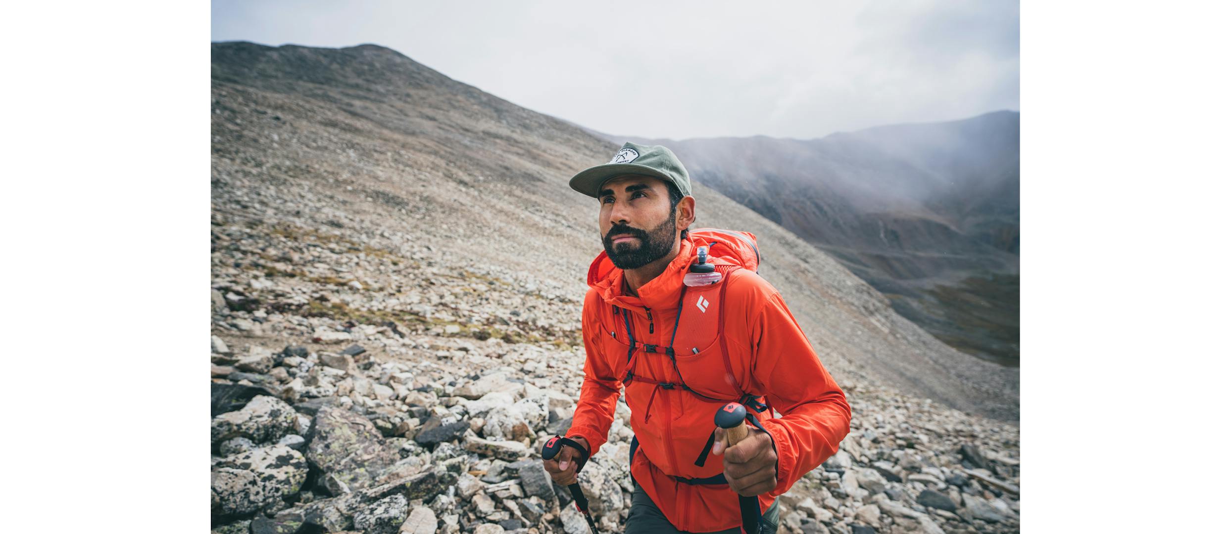 A Hiker wears the Alpine Start Hoody to stay warm high up on a ridgeline. 