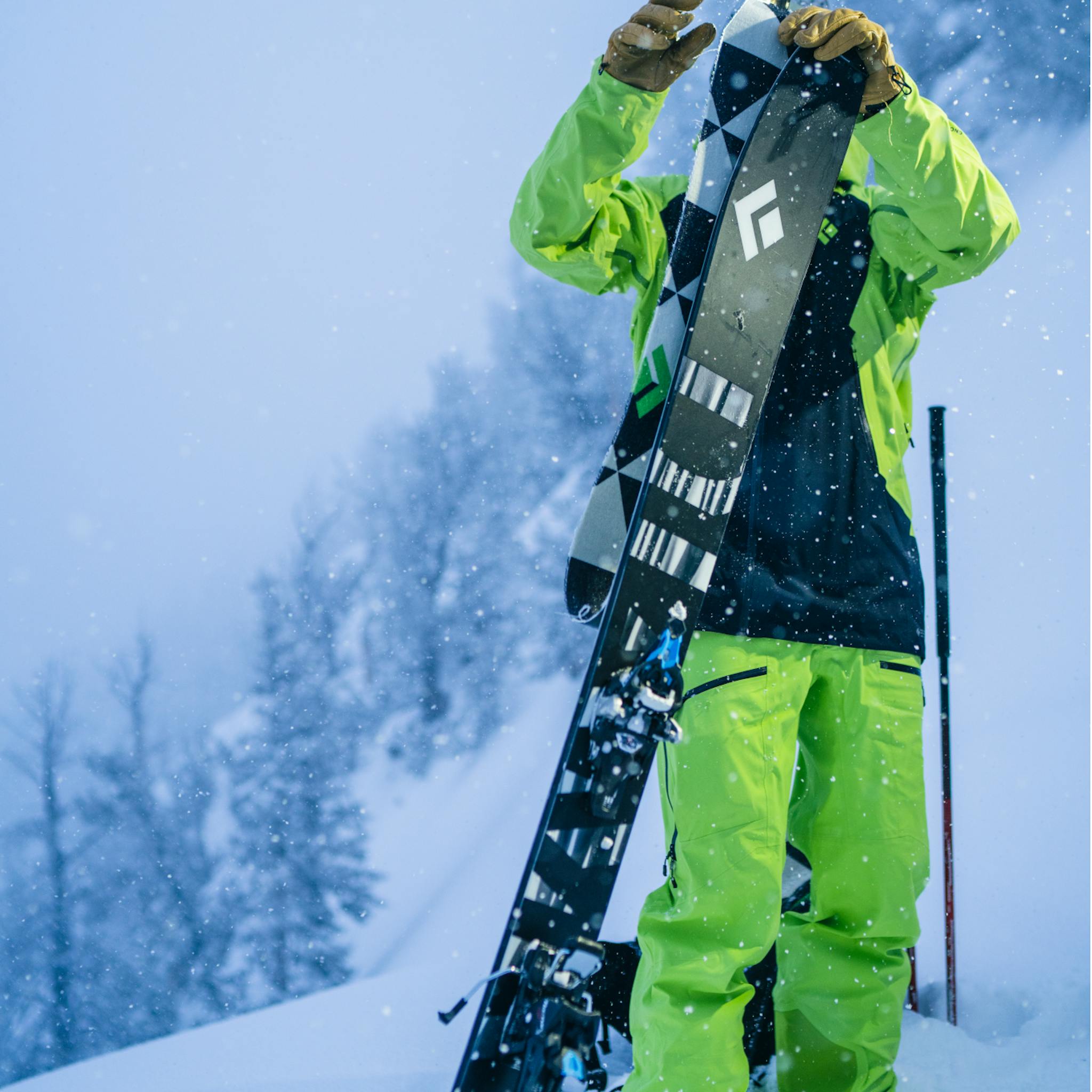 A skier puts skins on his Impulse 104 Skis with
