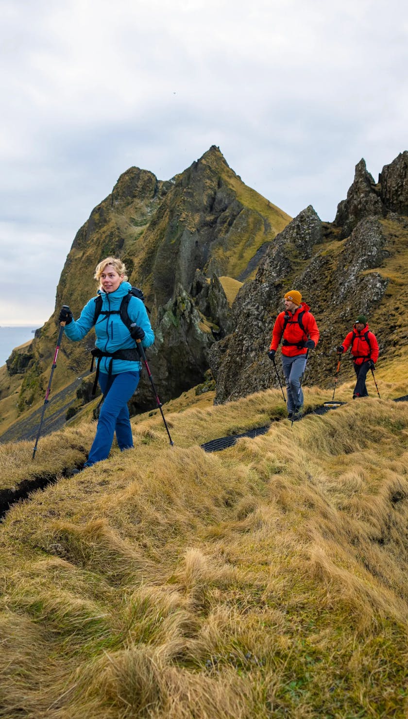 Friends of Black Diamond using Trail series trekking poles to hike up a mountain in Iceland. 