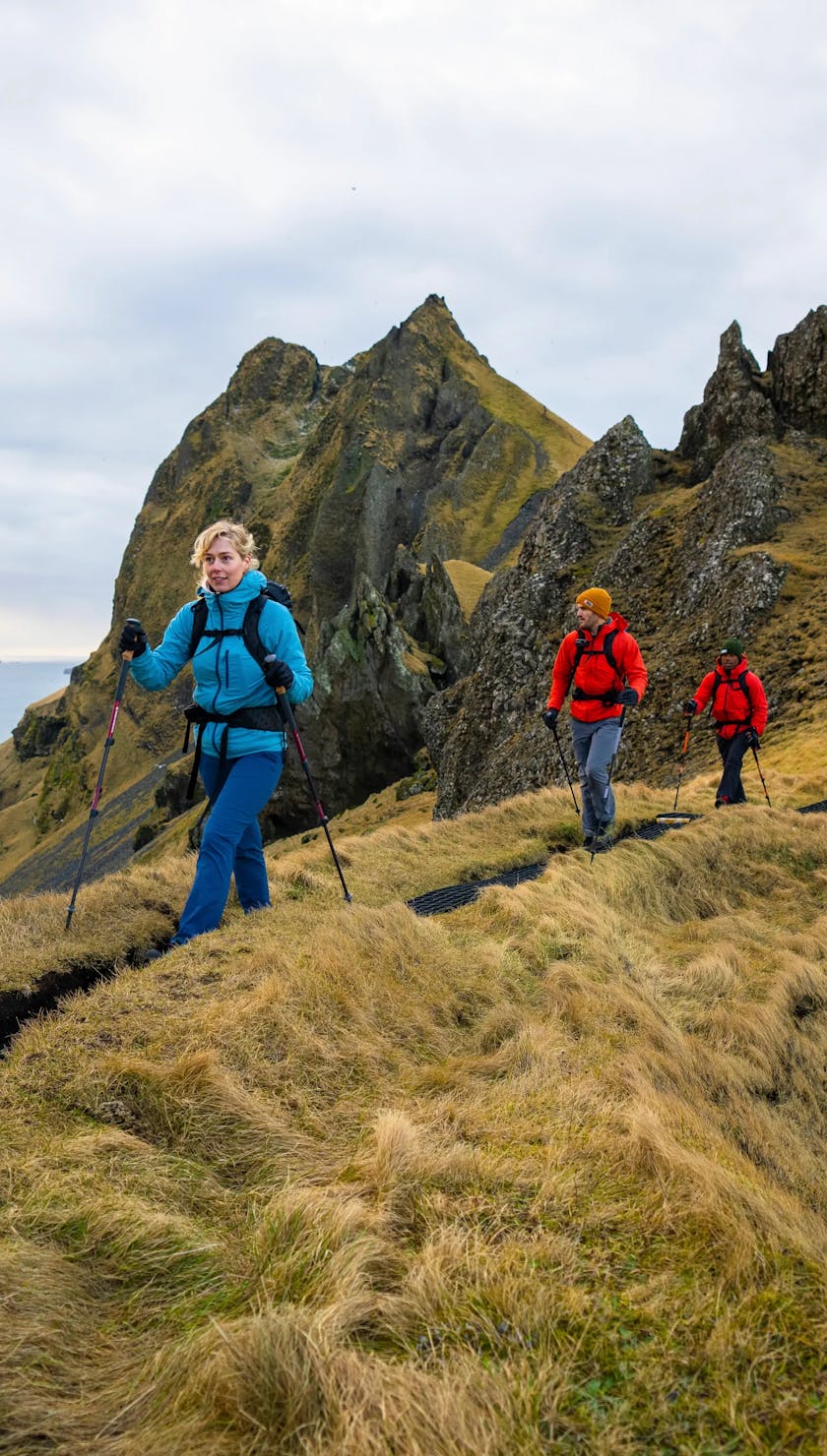 Friends of Black Diamond using Trail series trekking poles to hike up a mountain in Iceland.