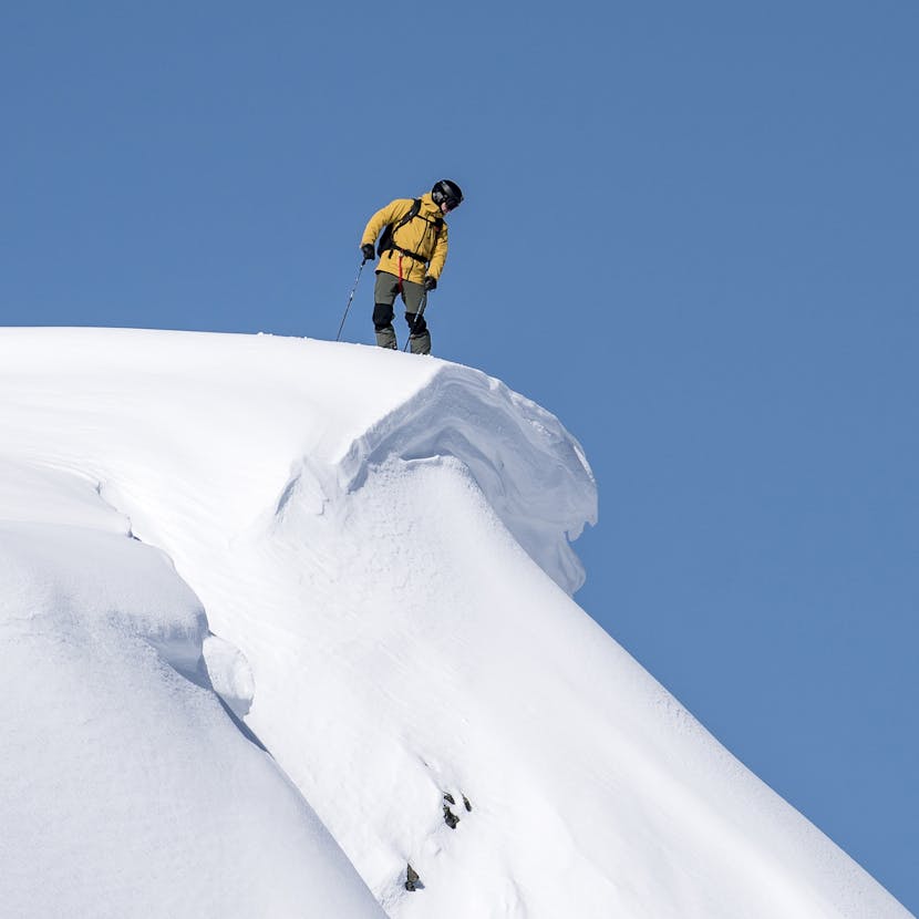 Black Diamond Athlete Tobin Seagel looking over a cornice in BC, Canada.