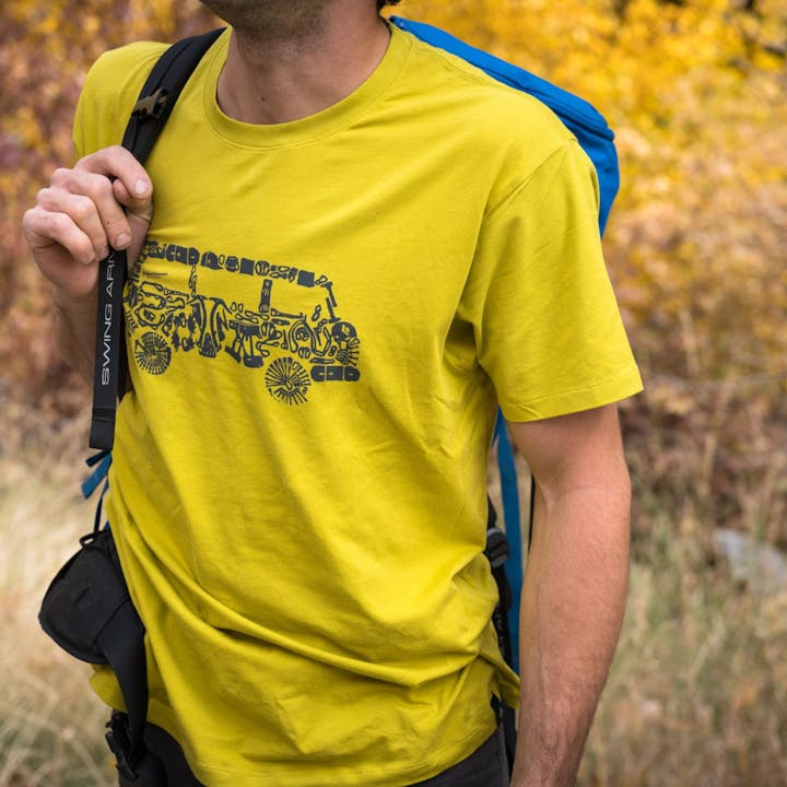 Photograph by Andy Earl of a man holding a pack | Men's Tees