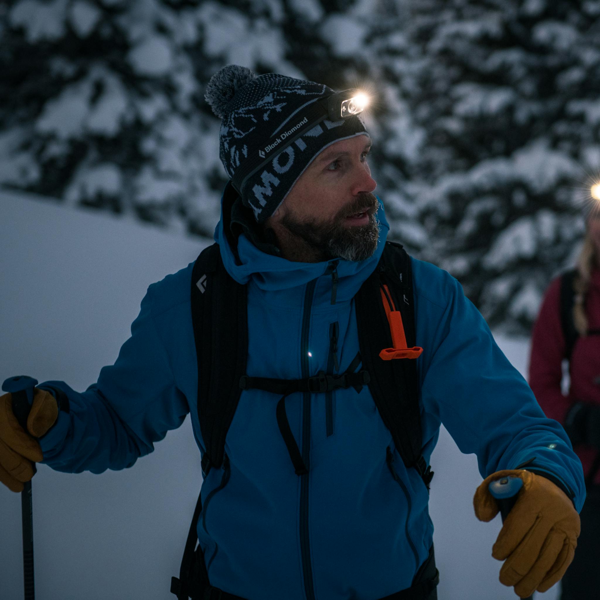 A backcountry skier wearing the Dawn Patrol Shell.