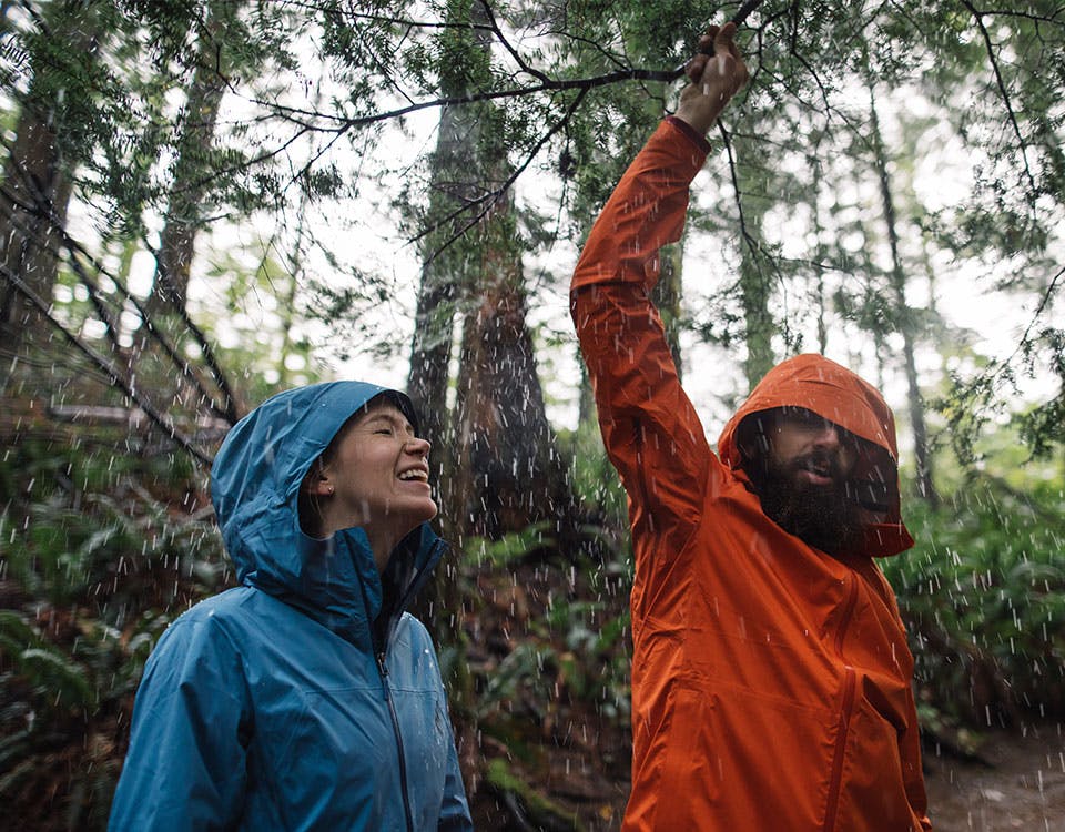 man and woman enjoying the rain