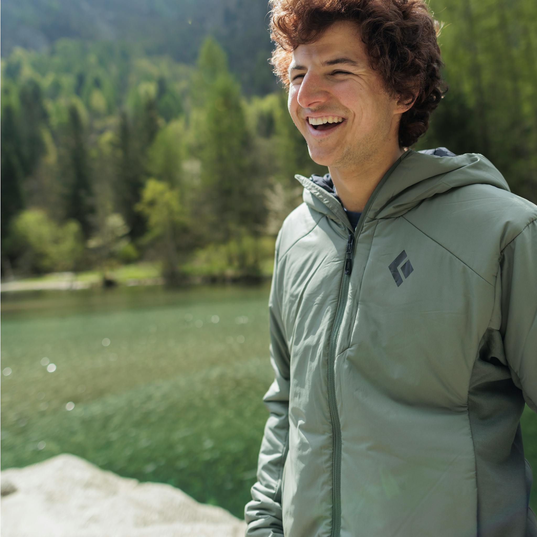 A hiker wearing the First Light Hybrid Hoody.