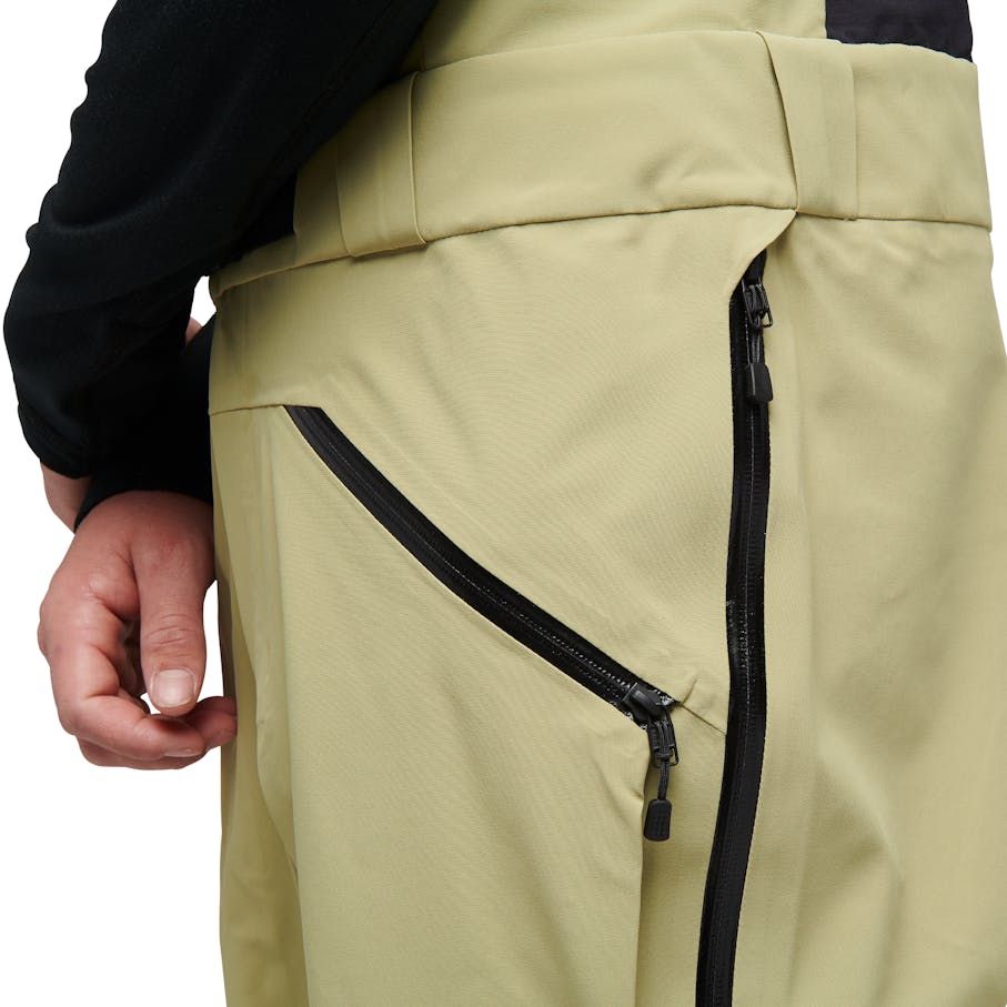 Quick-access electronics pocket and zipper vents on either side for ventilation.