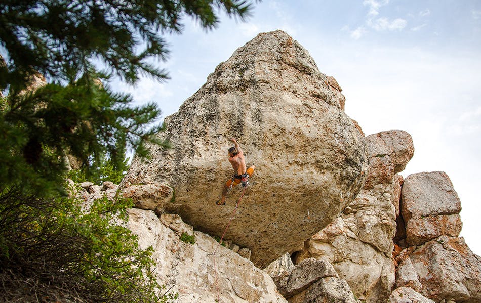 Photograph of Sam Elias rock climbing outdoors.