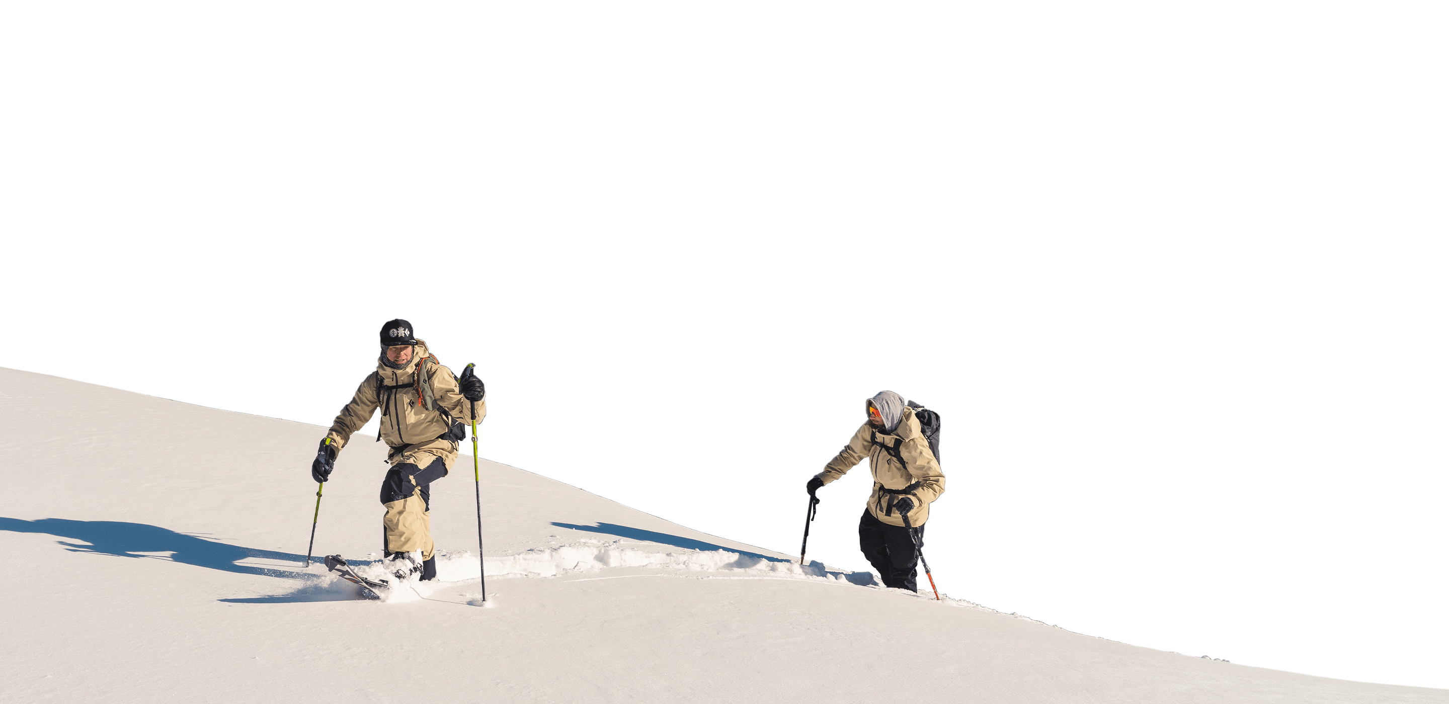 Two splitboarders skinning in the backcountry.