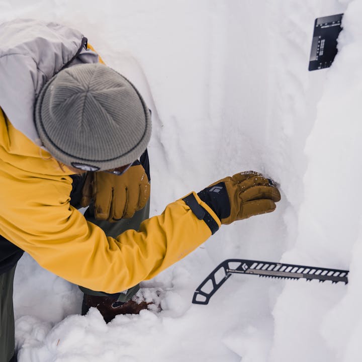Black Diamond athlete Bjorn Leines working in a snow pit. 