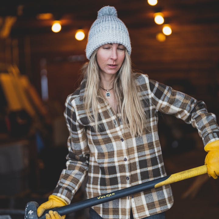 BD Athlete Kelly Haplin chops wood in a Project Flannel.