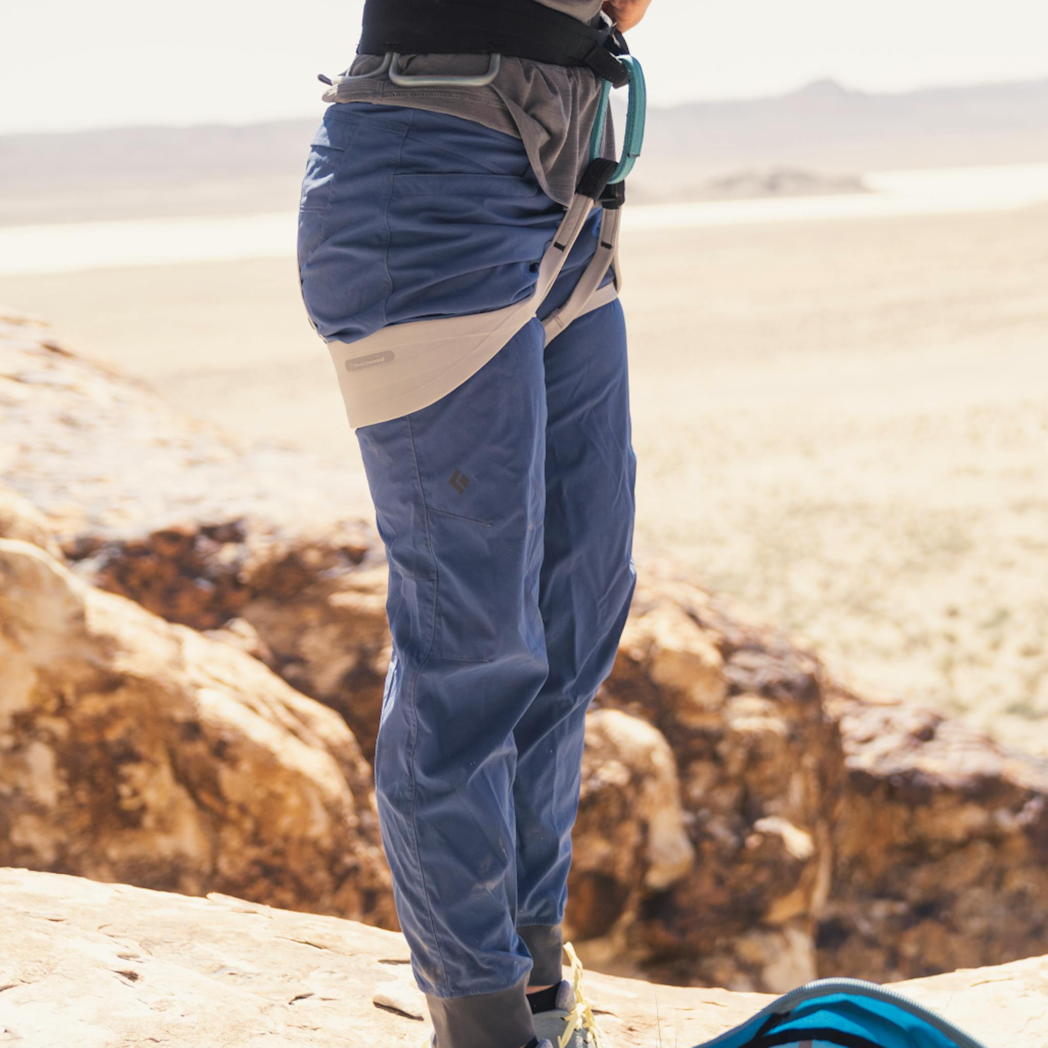 A climber adjusts her Black Diamond Harness.