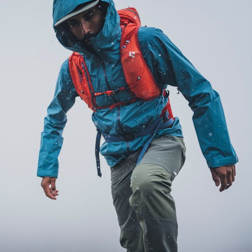 A hiker wearing the Black Diamond Stormline Stretch shell and Pursuit 30 pack.