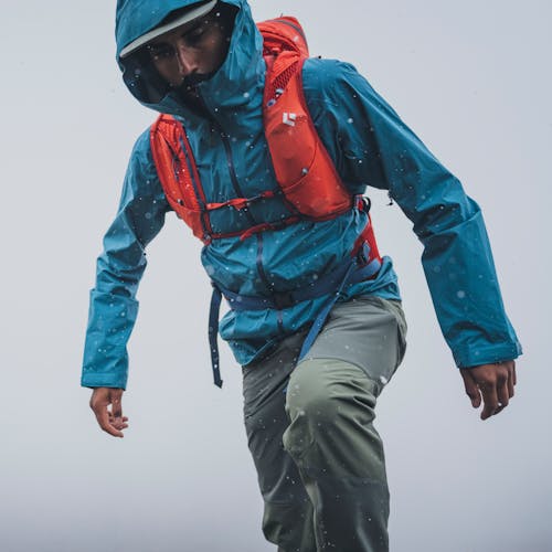 A hiker wearing the Black Diamond Stormline Stretch shell and Pursuit 30 pack.  