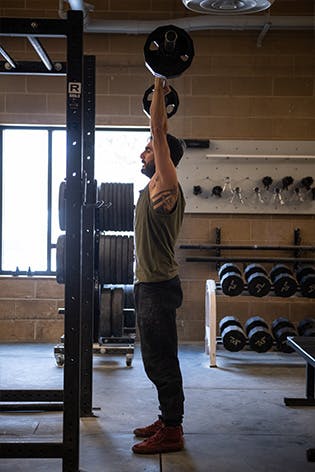 Sam Elias performing an overhead press
