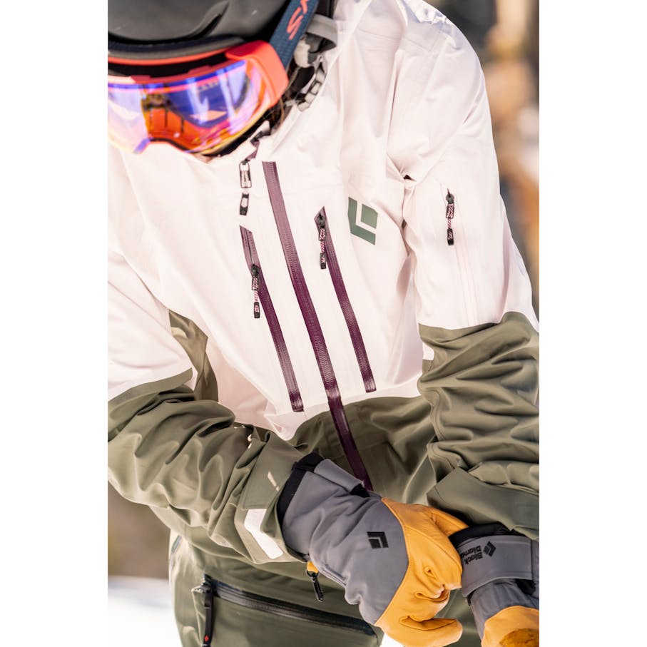 A skier pulls on a pair of Legend Ski Gloves