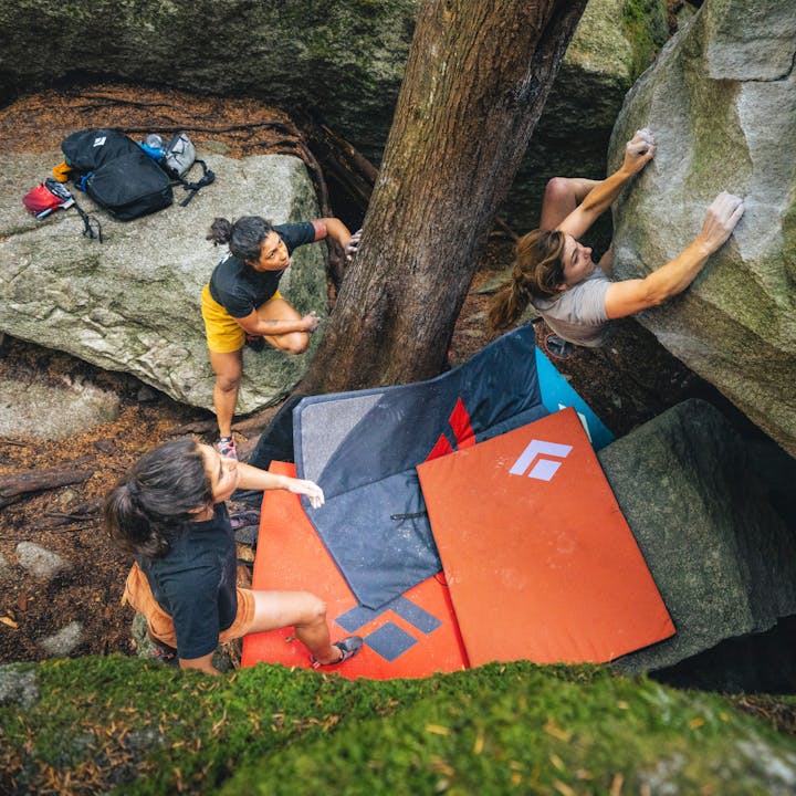 BD athlete Collette McInerney is spotted by her friends while bouldering. 