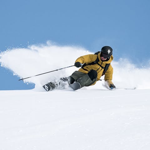 Black Diamond Athlete Tobin Seagel spraying powder on the Impulse Skis in BC, Canada.