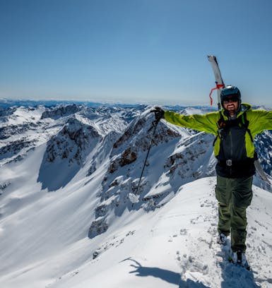 A portrait of Black Diamond ambassador Justin Morgan standing on a ridge in the backcountry.