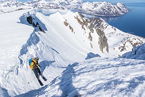 Photo of Antte Lauhamaa skiing in the mountains.
