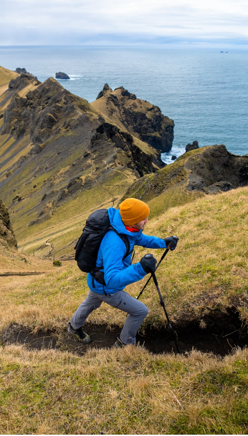 Friends of Black Diamond using Trail series trekking poles to hike up a mountain in Iceland.