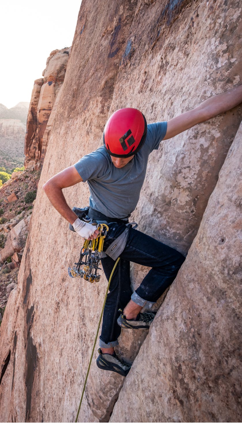 Climber using Black Diamond Equipment to ascend a desert crack.