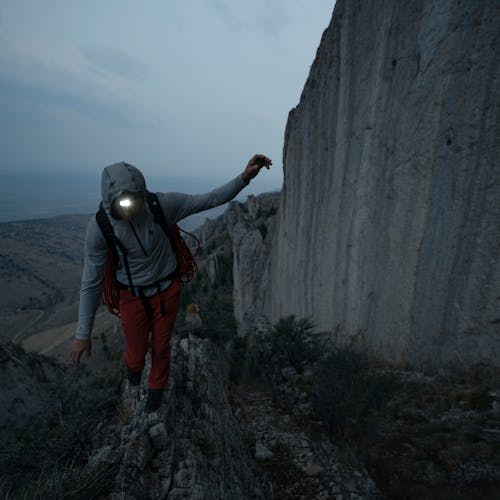 A climber wearing the new Storm 500-R Headlamp.